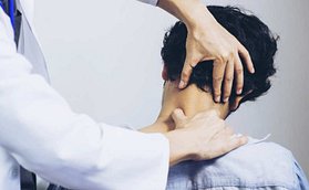Physical Therapist preforming manual therapy on patients neck