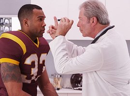 Football player getting an eye exam